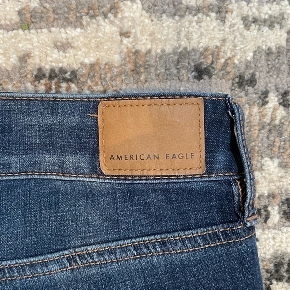 American Eagle | Highrise Next Level Stretch Destressed Dark Blue Jean - Picture 7 of 11